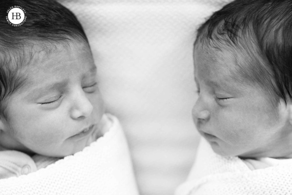 newborn twins sleep facing each other