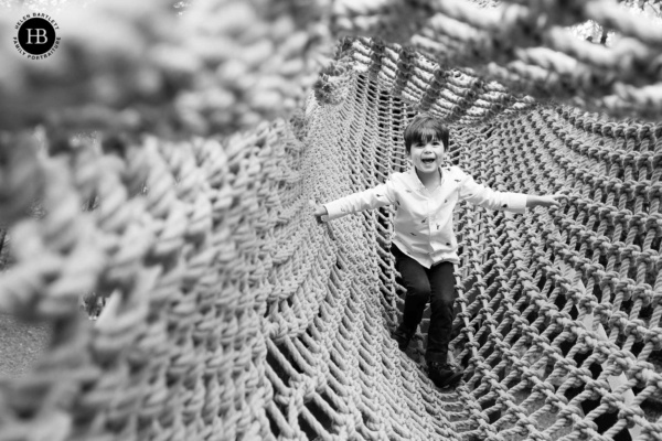 classic styles are perfect for family photographs as we see in image of little boy playing in scramble nets