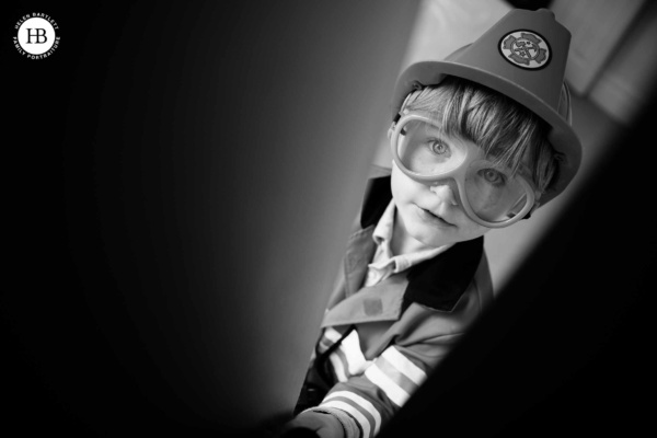 imaginative play boy dressed as firefighter