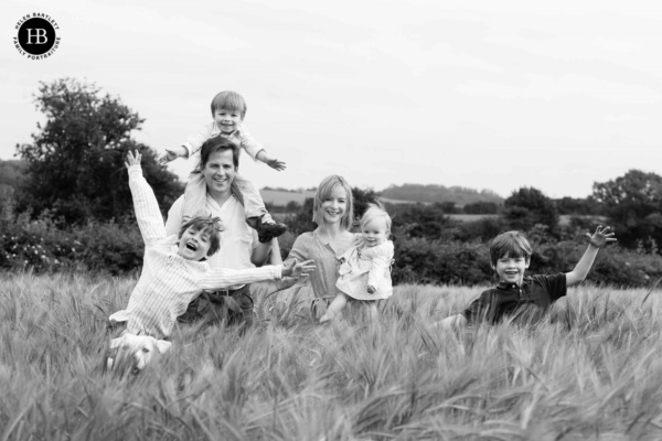 family-laugh-together-in-field-professional-family-photo