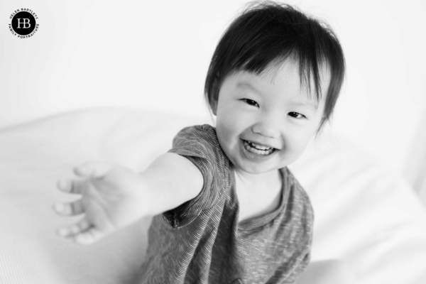 baby-plays-on-bed-during-blackheath-family-photography-session