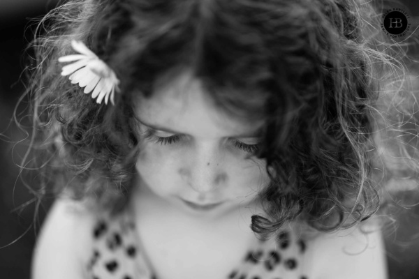 portrait of a young girl shot from above to show eyelashes with a shallow depth of field, victoria park in east london