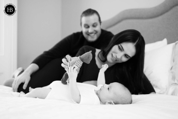 parents-play-with-baby-on-bed-during-family-photo-shoot-primrose-hill