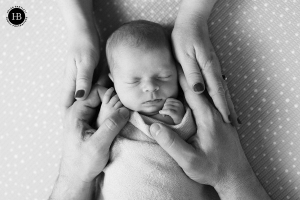 parents-hold-newborn-baby-professional-photo