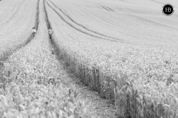 children-run-through-field-corn
