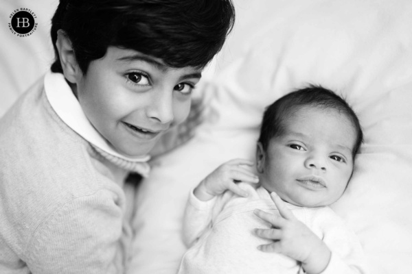 newborn-baby-and-five-year-old-boy-looking-at-camera