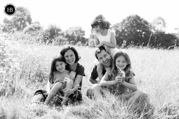 laughing-family-photo-in-sunlit-field