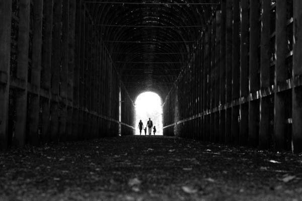 An archway frames a family silhouette.