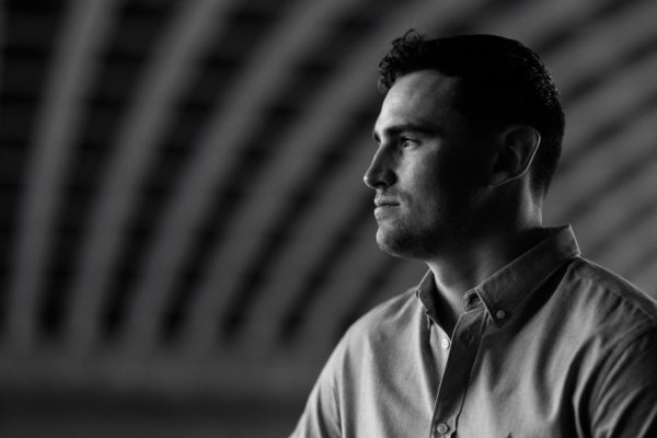 Atmospheric portrait of a young man in black and white.