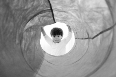 A baby looks down a tube.