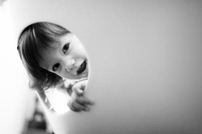 A baby looks through a peephole.