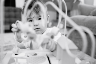 Baby concentrates while they play a game.