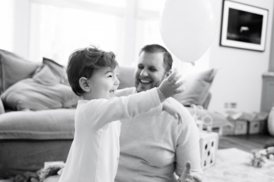 A baby plays with a balloon in the family home.