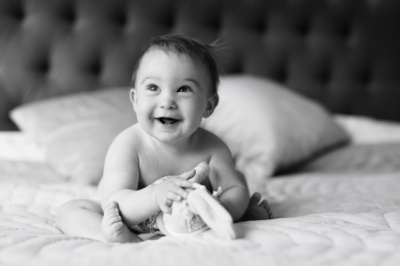 Baby portraits on a bed.