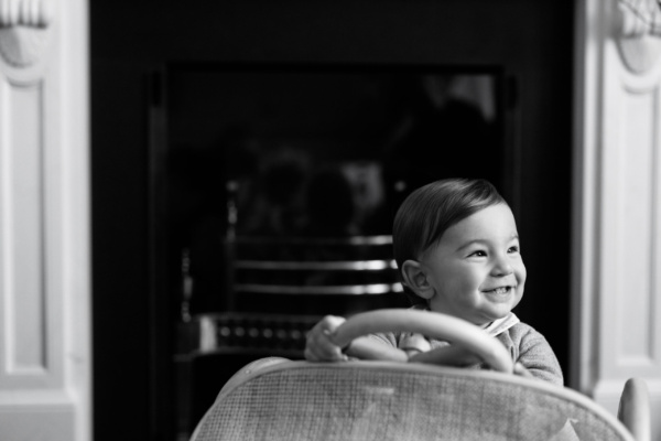 Baby rides a toy car in the family home.