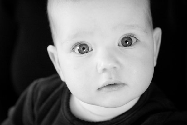 Baby stares at camera.