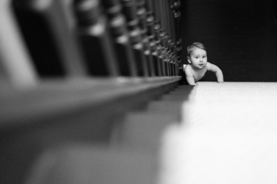 A baby begins climbing stairs.