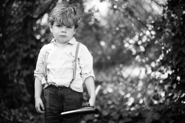 A boy in braces holds a toy.