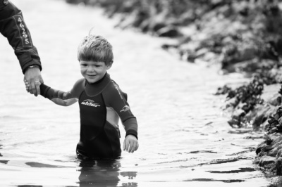 A boy plays in a rockpool.