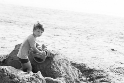 A boy plays in the sand.