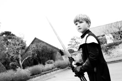 Boy plays with light sabre.