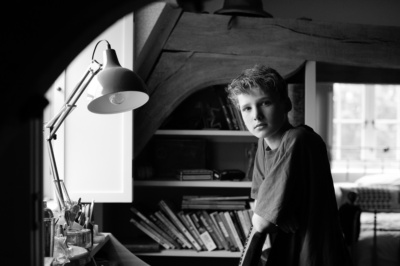 A boy sits at his desk.