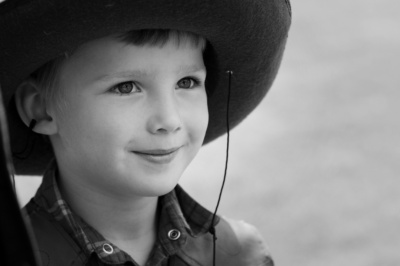 A boy wears a cowboy hat