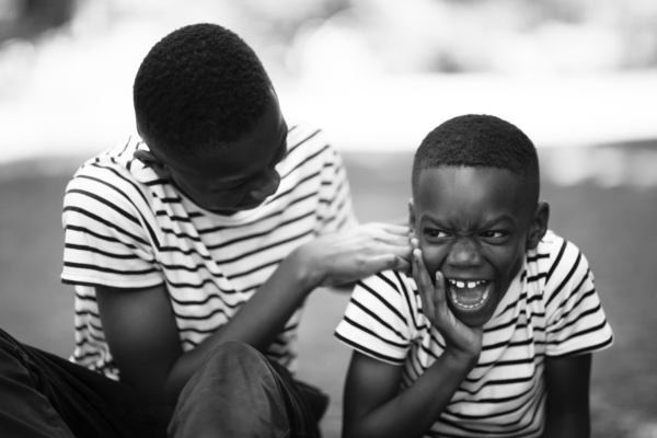 Two brothers giggle together during a London shoot.