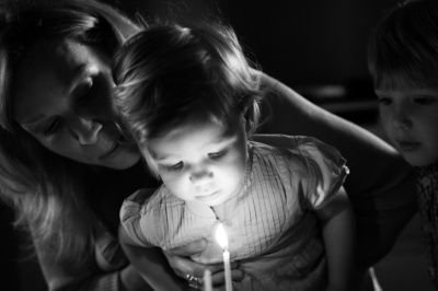 A child blows out their birthday candles.