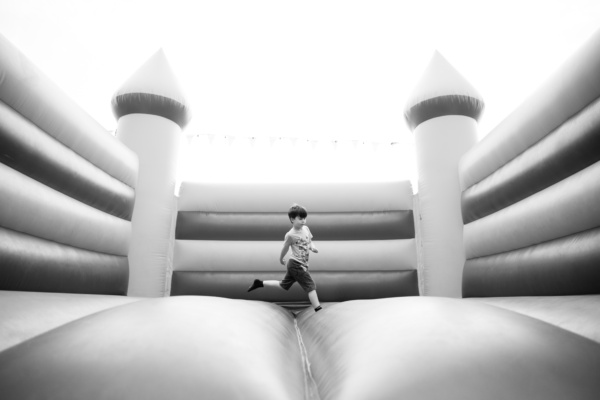 A child jumps in a bouncy castle.