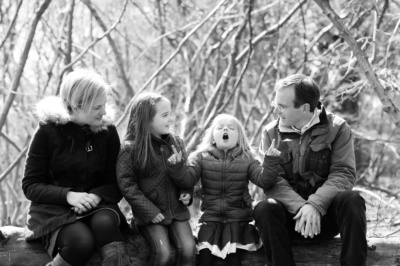 A child entertains their parents and sibling.