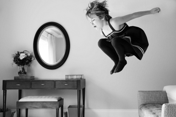 A child jumps off their bed.