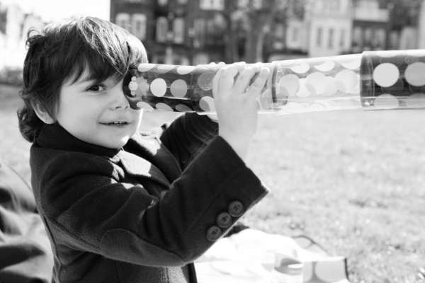 A child looks through a toy.