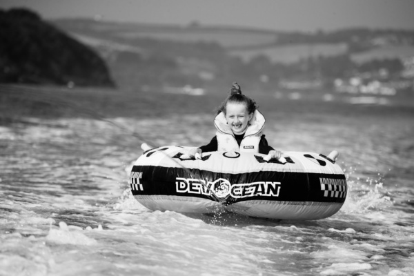 A child towed across the water on an inflatable.