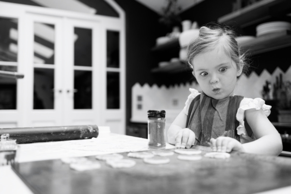 A child pulls a surprised face when baking.