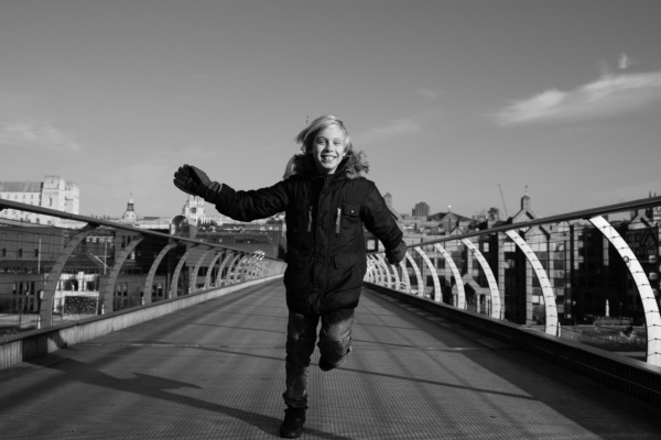 A child runs along the Millennium Bridge.