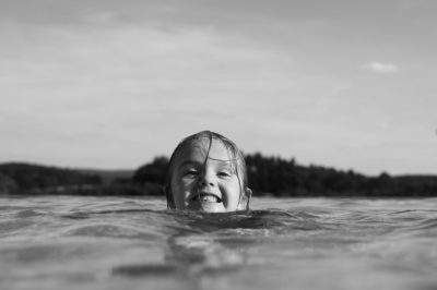 A child swims through water.