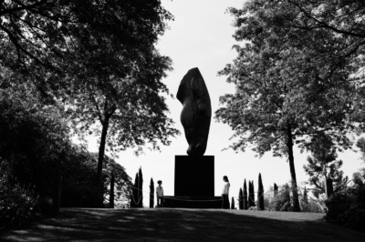 Children in a sculpture park, silhouetted against the sky.