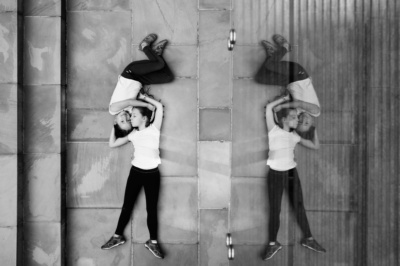 Two children lay on the floor for birds-eye portraits.