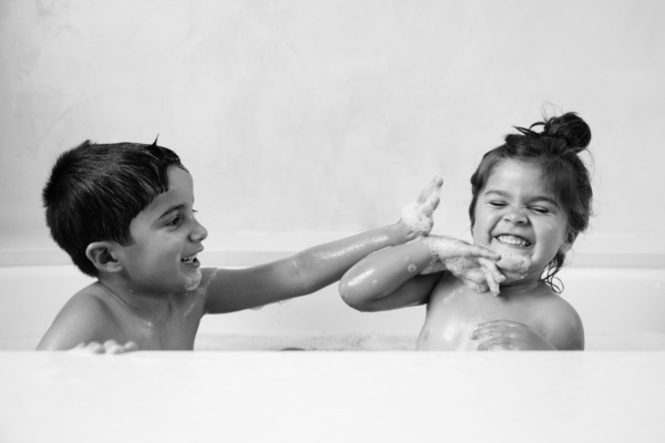 Children play in a bubble bath.