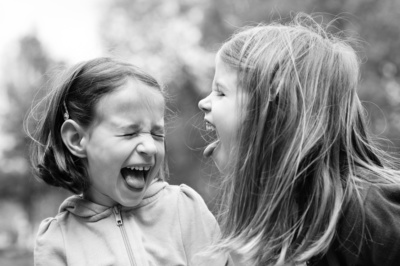 Children stick out their tongues and laugh.