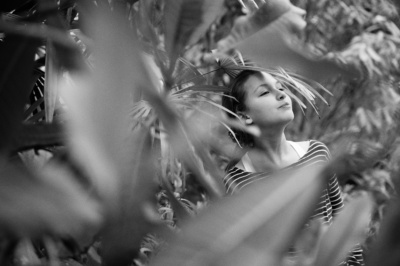 A child's portrait with greenery.