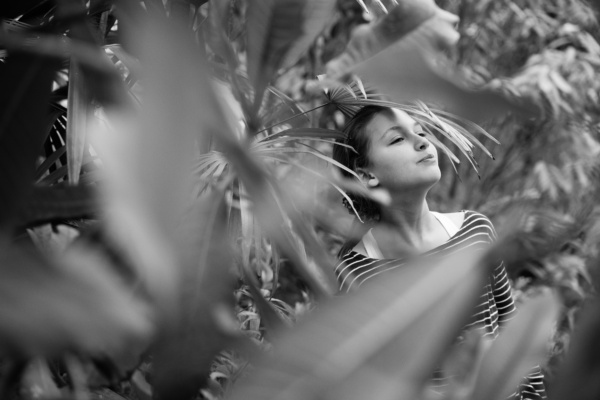 A child's portrait with greenery.