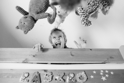 A child throws toys into the air.