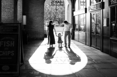 Parents and their daughter walk through Hays Galleria on London's south bank of the Thames.