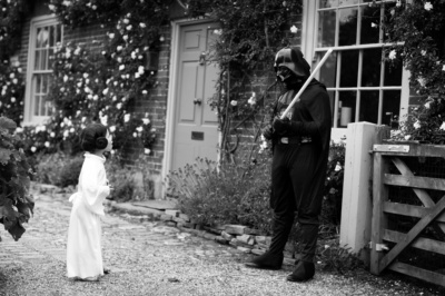 Family dresses up as Star Wars characters Princess Leia and Darth Vader.