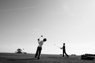 Two members of the one family play golf together.