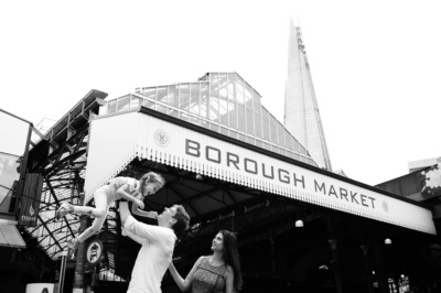 A family of three play together at Borough Market, London.