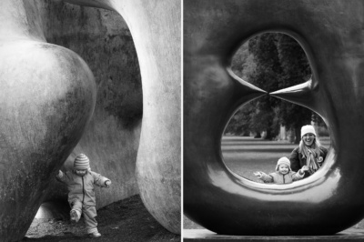 Family plays around sculpture.