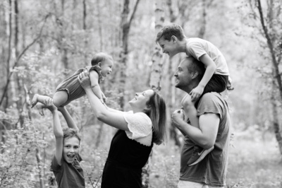 A family portrait in woods with three children.